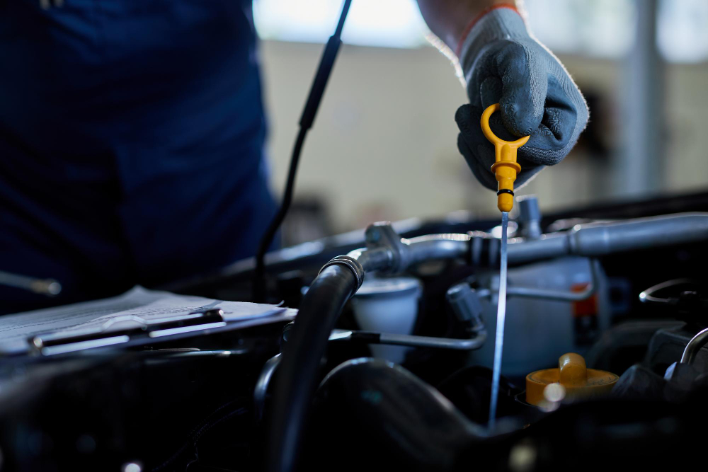 closeup auto repairman checking car oil workshop 1